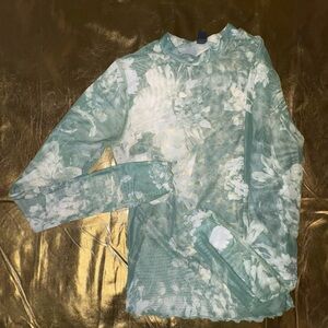 green and white floral patterned long sleeve mesh top
